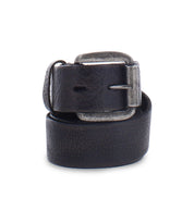 The Drifter belt by Bed Stu, featuring clean and solid black leather and a worn silver buckle, rolled up against a white background, adds dapper appeal to any ensemble.