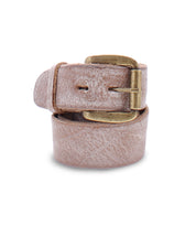 The Bed|Stü Drifter Belt Buckle Bundle features a rolled-up light brown premium leather belt with a vintage buckle, displayed elegantly against a white background.