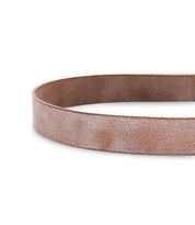 A close-up image of the Drifter brown leather belt by Bed Stu, laid flat in an oval shape on a white background, showcasing its dapper appeal as the perfect weekend accessory.