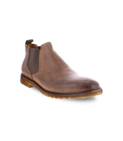 The Elude boot by Bed Stu, a men's leather Chelsea boot in brown featuring elastic side panels and a light brown rubber sole, is handcrafted in Italy and displayed against a white background.