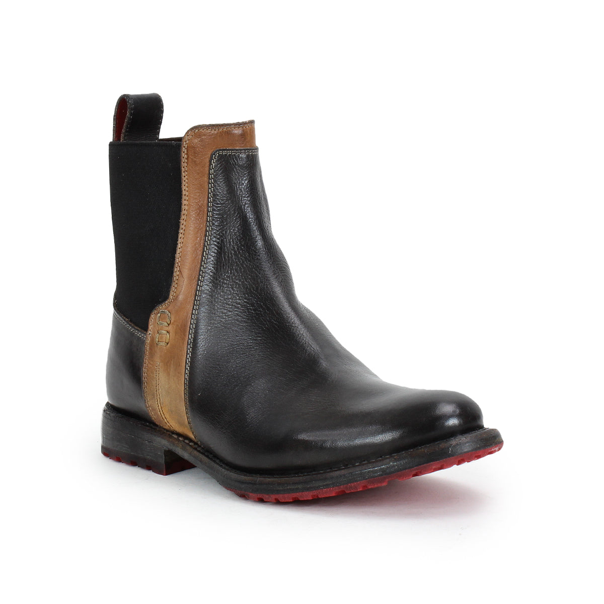 The Bed Stu Ethic is a black vegetable-tanned leather Chelsea boot with a brown accent strip, elastic side panels, back pull tab, and vibrant red Vibram sole, shown on a white background.
