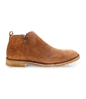 The Evade, a handcrafted tan suede ankle boot by Bed Stu, features a side zipper and a light brown rubber sole.