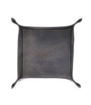 A square leather catchall tray with slightly raised edges and visible stitching, perfect for holding loose change and keys. The word "Bed Stu" is embossed in the center.