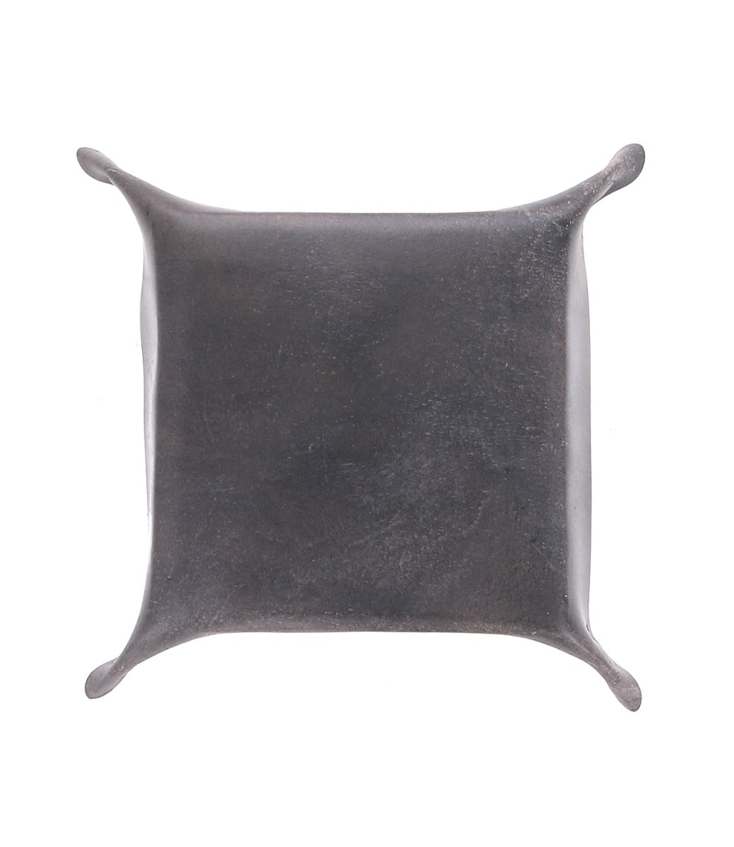 An Expanse square black leather pillow on a white background. (Brand: Bed Stu)