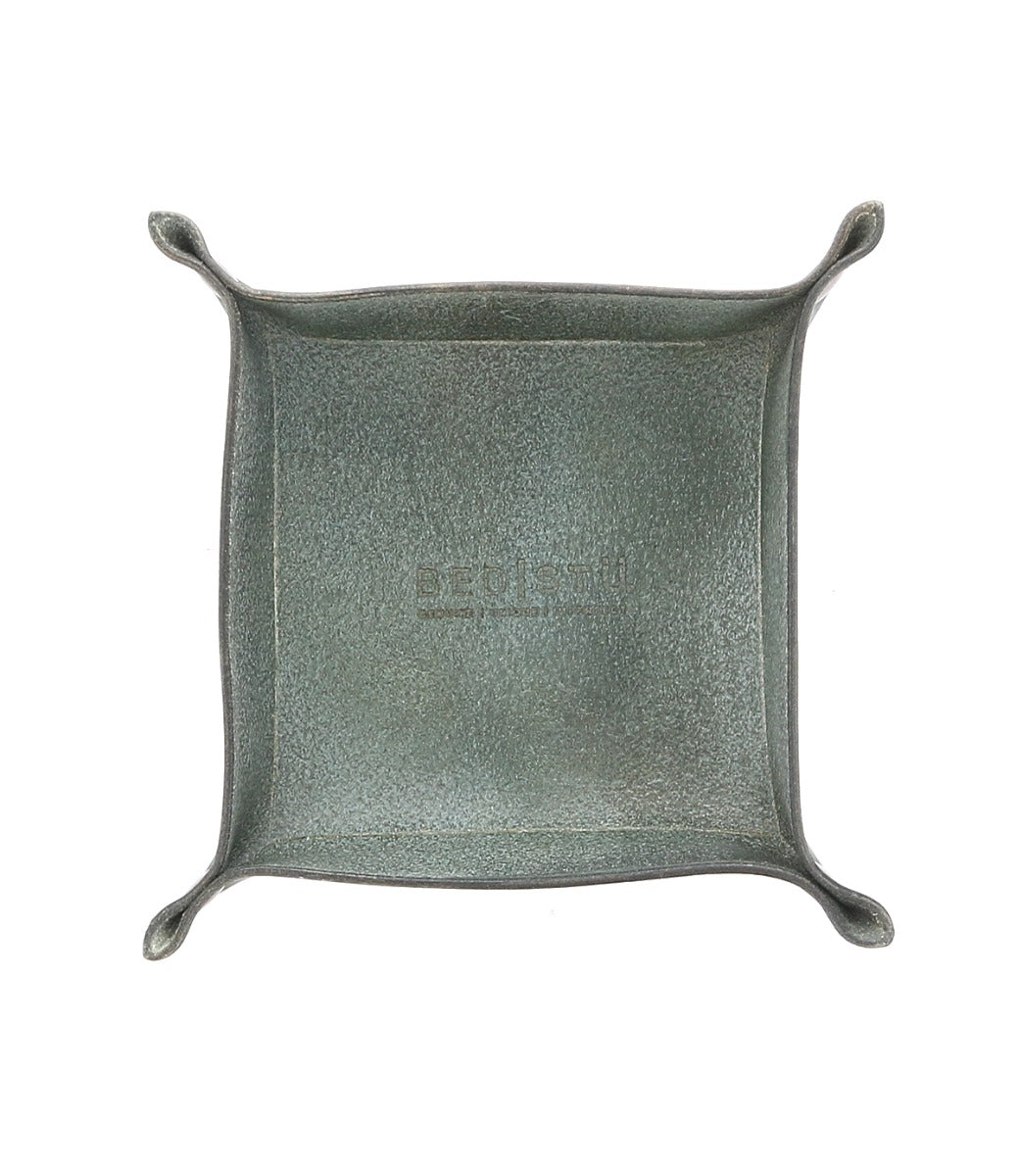 An Expanse metal tray with a handle on it.