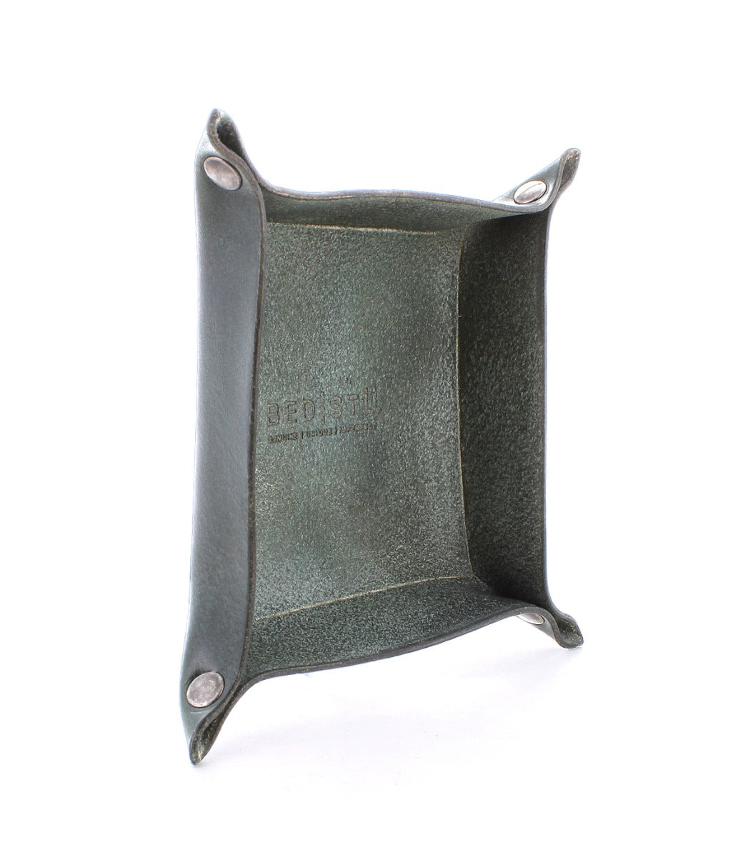 An Expanse square black leather tray with two screws on it by Bed Stu.
