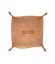 Top-down view of an empty, square, brown leather Expanse Catchall Tray with slightly curved edges and "Bed Stu" embossed in the center, perfect for holding loose change and keys.