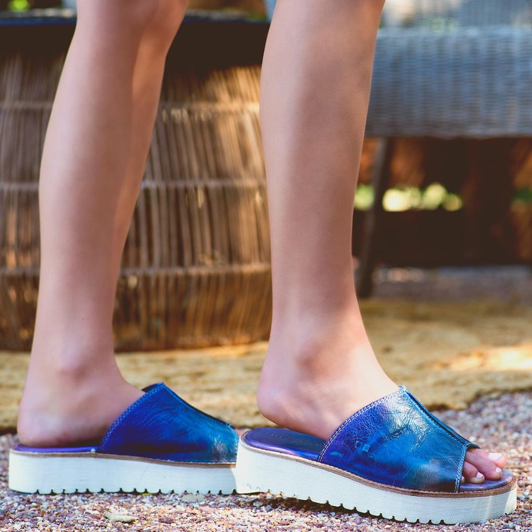 A woman's feet in Bed Stu Fairlee II sandals.