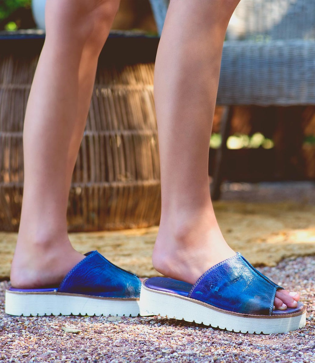 A woman's feet in Bed Stu Fairlee II sandals.