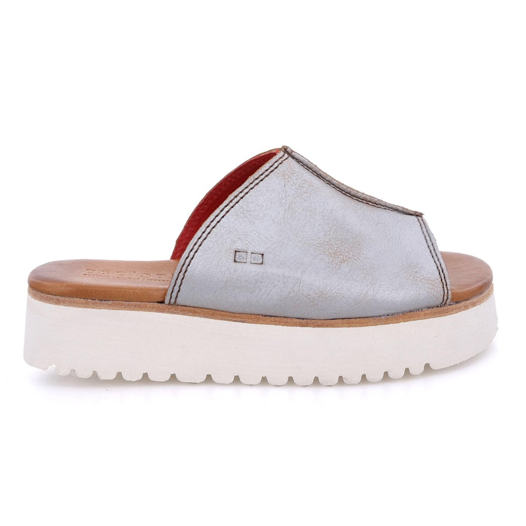 A women's Fairlee II slipper with a red sole by Bed Stu.