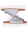 A pair of Bed Stu Fairlee II women's silver sandals with white soles.