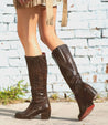 A woman wearing Bed Stu black boots.