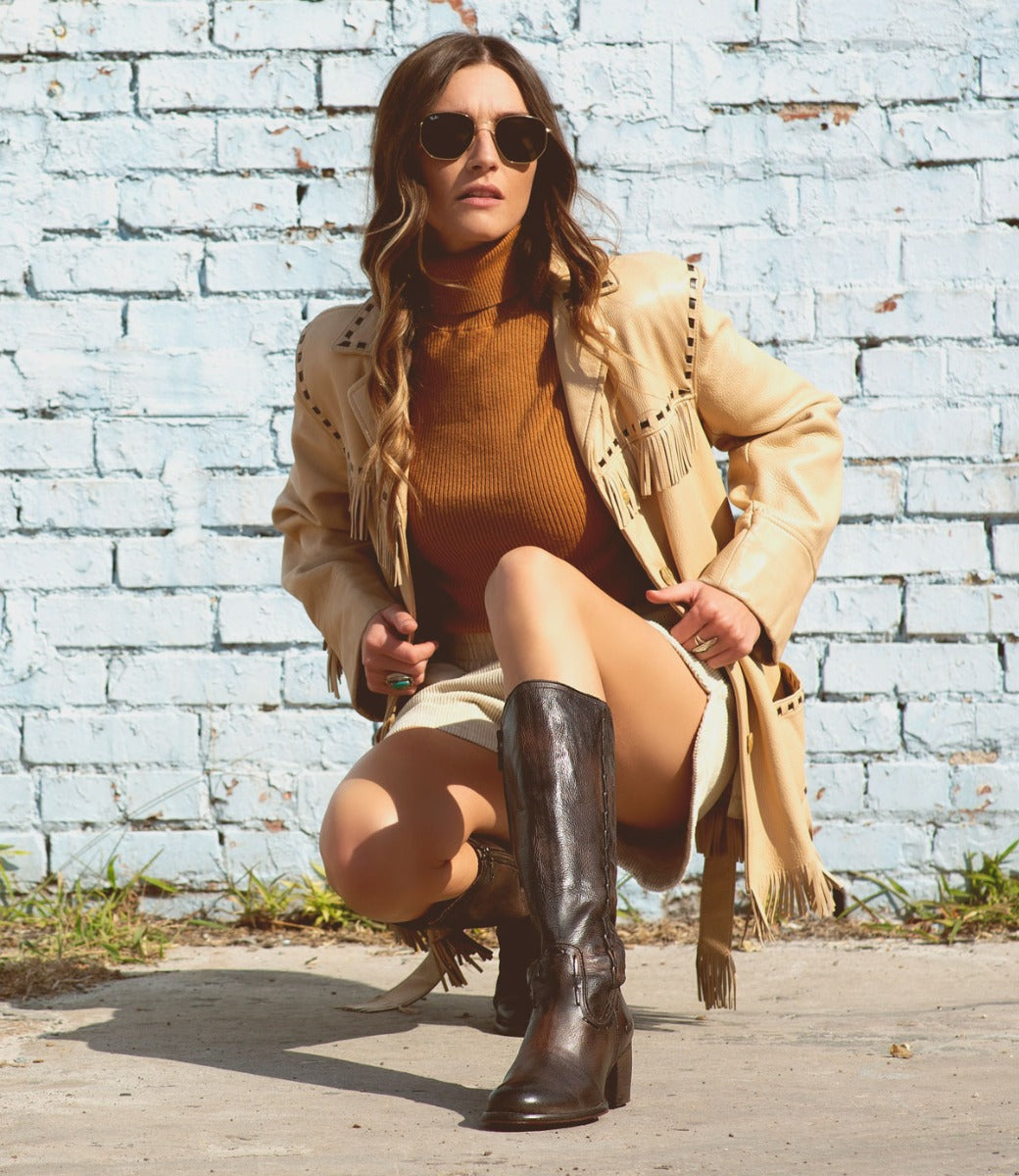 A woman wearing Bed Stu Fate black leather boots.