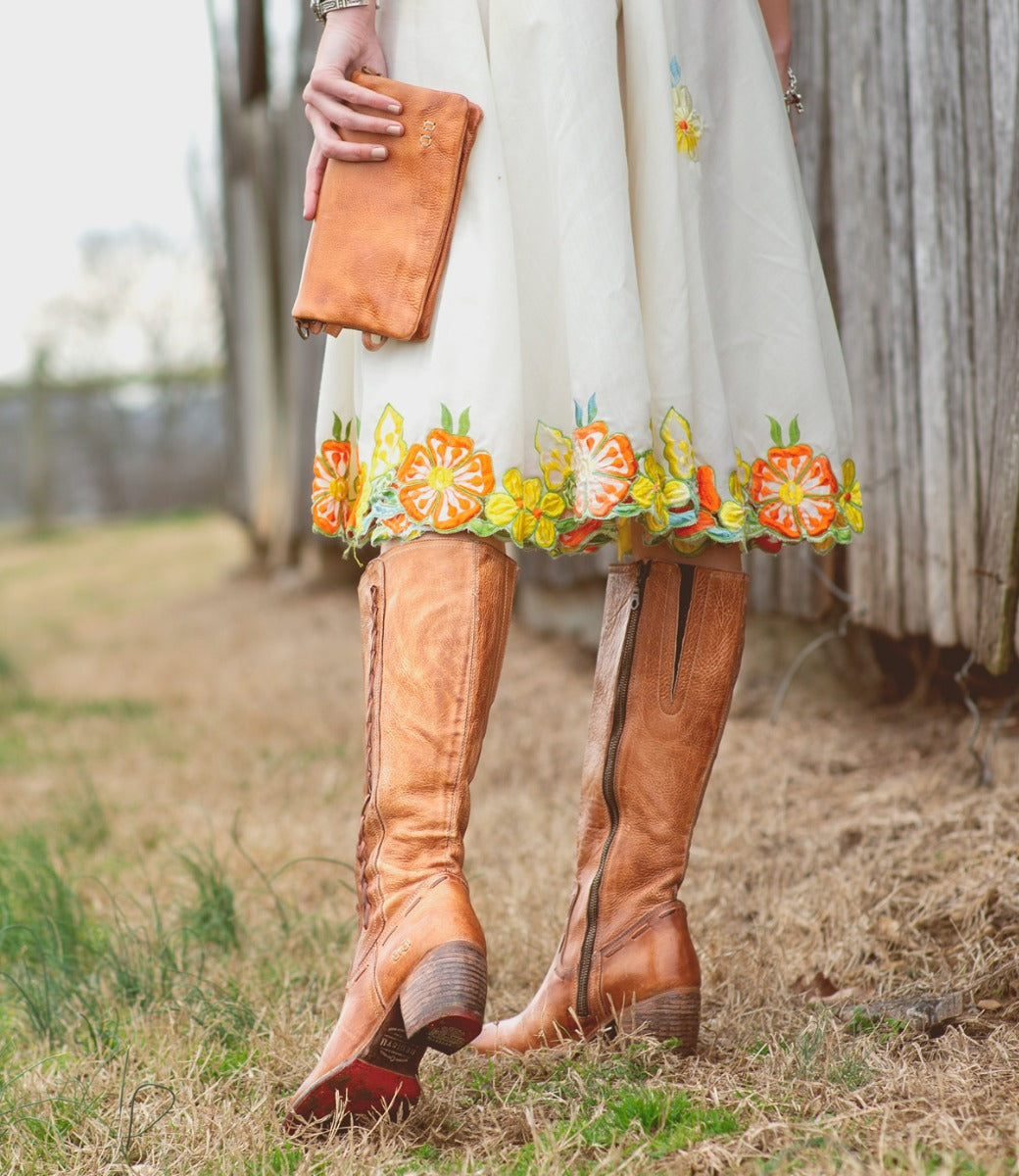 A woman wearing Bed Stu Fate tan leather boots.