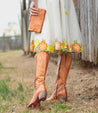 A woman wearing Bed Stu Fate tan leather boots.