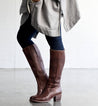 A woman wearing teak leather Fate boots with zipper on the side, made by Bed Stu.