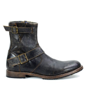 Introducing the Bed Stu Fellow, a rugged dark brown men's leather boot featuring two buckle straps and a low heel, crafted in a moto-inspired style. This side-view highlights its exquisite Goodyear welted construction for durability and timeless appeal.