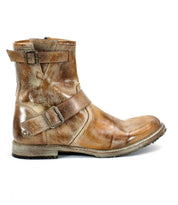 The product image showcases the Fellow boot by Bed Stu, a single moto-inspired brown leather ankle boot with adjustable straps and buckles, displayed from the side on a white background.