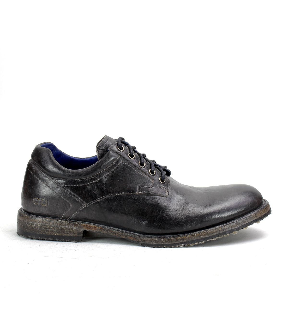 The Bed Stu "Fierce" is a black leather men's derby shoe with laces and a worn-looking sole, combining classic design with modern flair, showcased in side profile against a plain background.