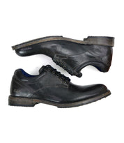 The "Fierce" men's derby shoes by Bed Stu in black leather, featuring laces and displayed from side and top views on a white background, seamlessly combine classic design with a contemporary twist.