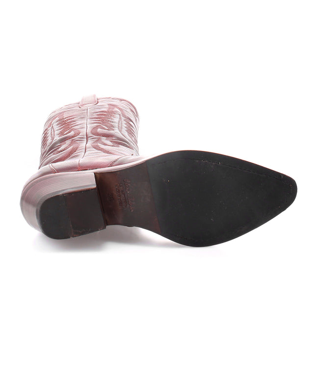 A pair of Bed Stu Finito leather cowboy boots with a distressed finish in western style, set against a white background.