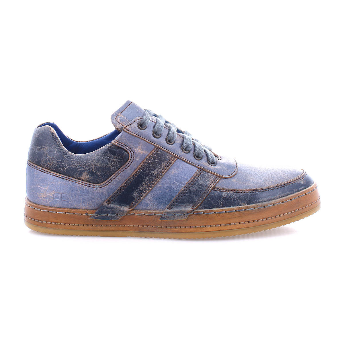 The Bed Stu Firepower men’s sneaker features blue and brown leather, lace-up design, white stitching, leather stripe accents, and a brown vulcanized rubber sole, shown in profile against a white background.