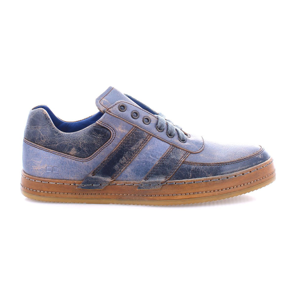 A side view of the Bed Stu Firepower men's sneaker showcasing a blue and brown casual design with leather stripe details, lace-up closure, and a brown rubber sole in a vulcanized style.
