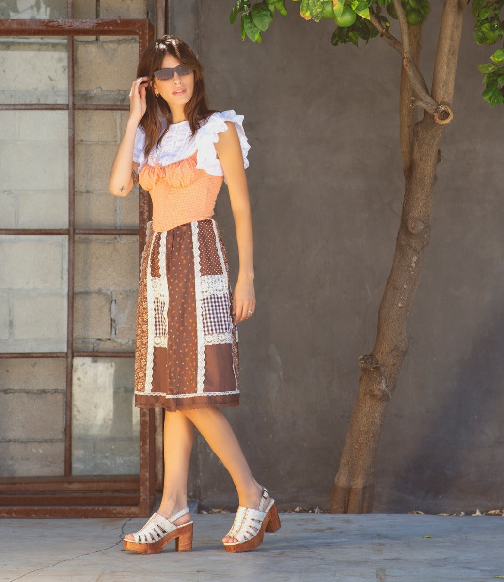A woman wearing a pair of Fontella by Bed Stu white platform sandals.