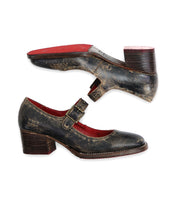 Two distressed black leather Bed Stu Forefront shoes with red interiors and stacked wooden heels, featuring an adjustable strap for classic elegance.