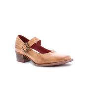 A single tan leather Mary Jane shoe with a mid-height comfortable heel and an adjustable strap secured by a metal buckle, known as the Forefront by Bed Stu.