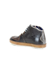 The Bed Stu Formation features a dark brown leather high-top sneaker with light brown accents, a tan sole, and sleek vulcanized style when viewed from the side.