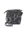 Ainhoa LTC black leather crossbody handbag by Bed Stu with an adjustable strap and front flap, featuring a secret pocket, isolated on a white background.