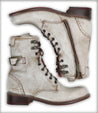 A pair of Anne white boots with a zipper on the side from the brand Bed Stu.