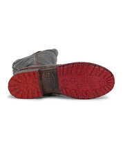 A pair of Jacqueline boots by Bed Stu with red soles.