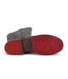A pair of Jacqueline boots by Bed Stu with red soles.
