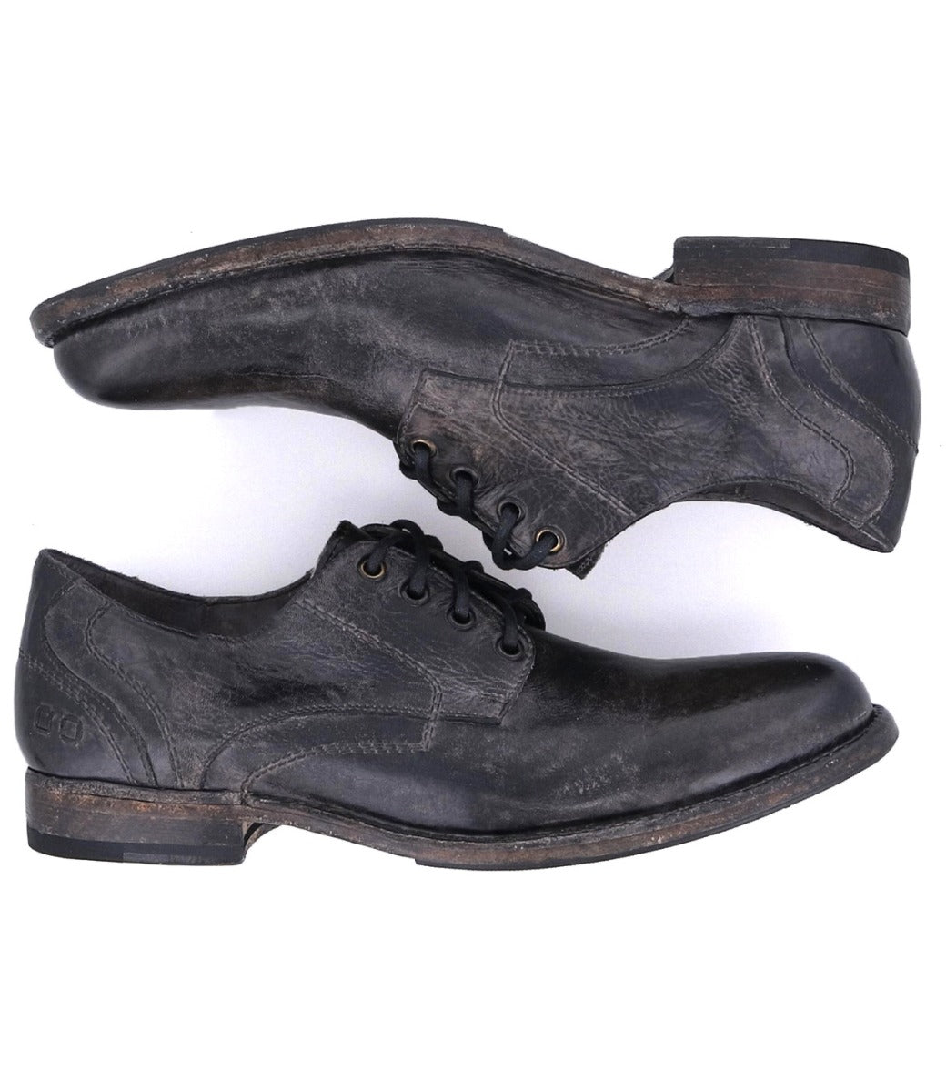 A pair of Bed Stu Galao men's black shoes on a white background.