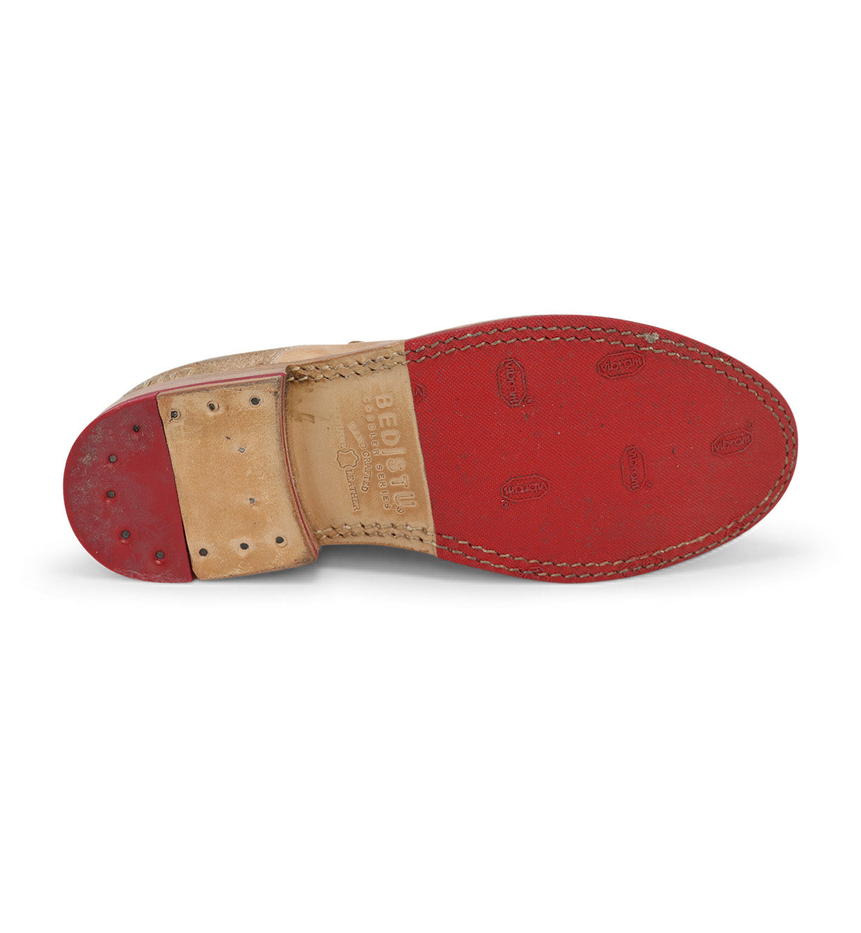 A pair of Bed Stu shoes with red soles on a white background.