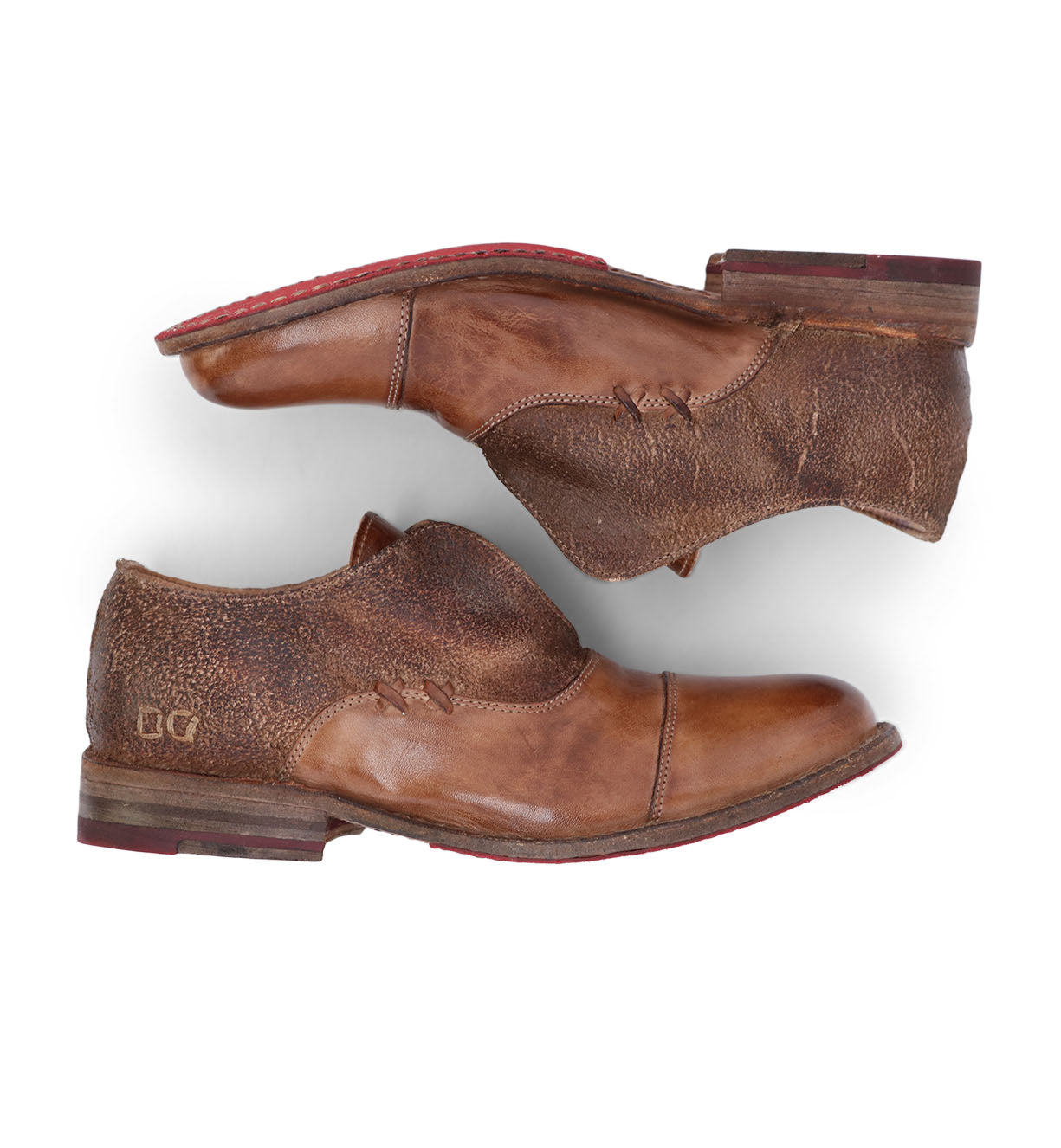 A pair of Bed Stu Garden M brown shoes with red soles.