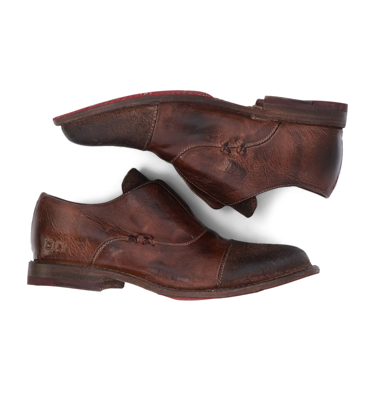 A pair of Garden M shoes by Bed Stu with red soles.