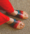 Woman wearing Gia colorful leather slide on sandals by Bed Stu.