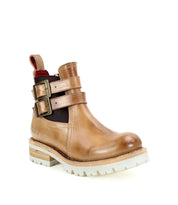 Introducing the Ginger II by Bed Stu: a tan leather Chelsea ankle boot adorned with stylish details such as two side buckles, an inner zipper for easy access, a white rubber sole, and a red pull tab at the back.