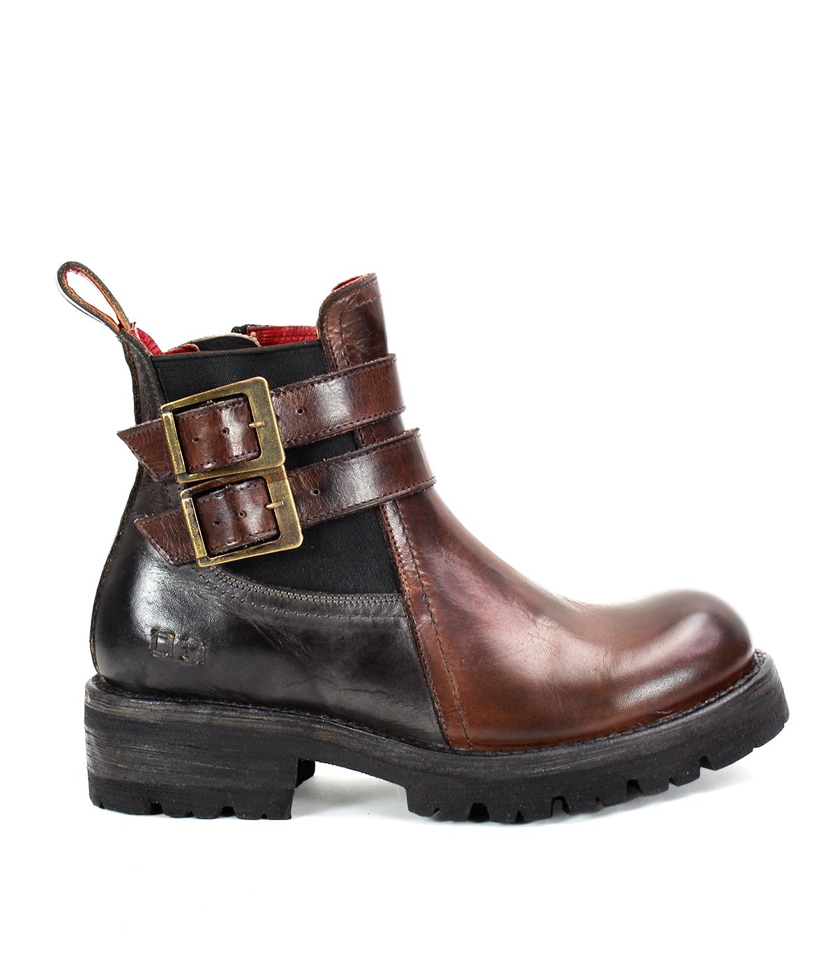 The Ginger II by Bed Stu is a brown leather Chelsea ankle boot, featuring two buckled straps on the side, a pull tab at the heel, and a thick black sole. It also includes stylish touches such as an inner zipper for easy wear.