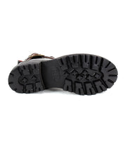 The bottom view of the Bed Stu Ginger II, a black Chelsea ankle boot with rugged soles and prominent tread patterns.