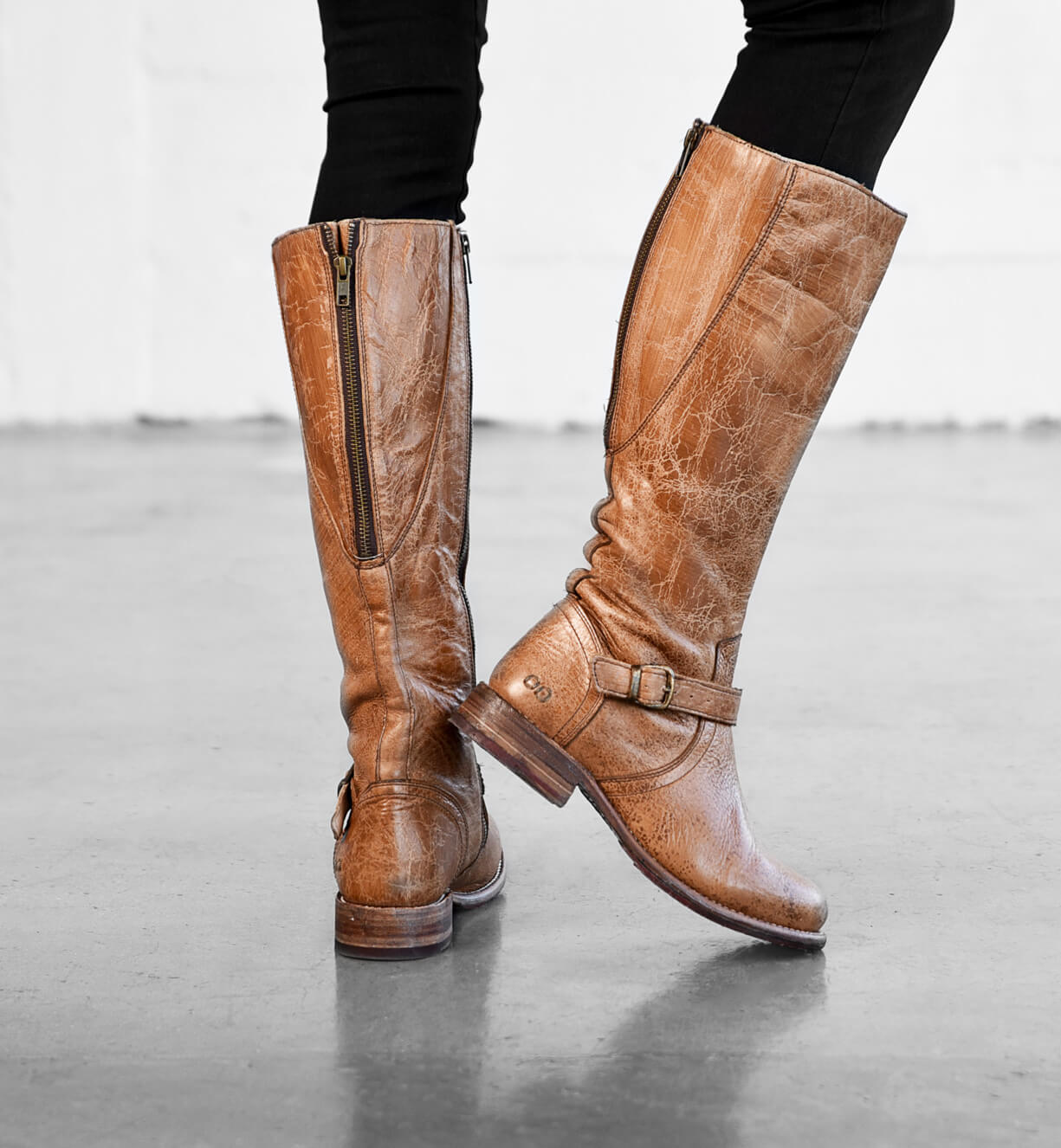 A woman's legs in a pair of Bed Stu Glaye riding boots.