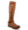 A women's brown riding boot with buckles, the Glaye boot by Bed Stu.