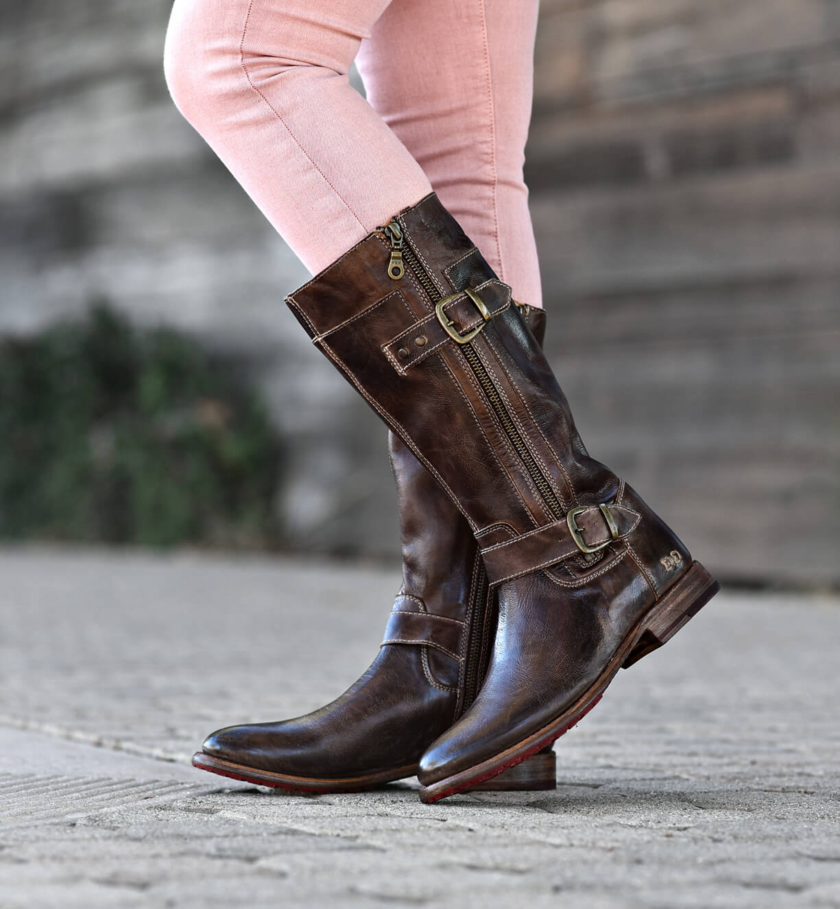 A woman wearing a pair of Gogo Lug boots by Bed Stu and pink pants.