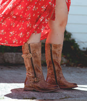 A woman wearing a red dress and Bed Stu Gogo Lug Wide Calf boots.