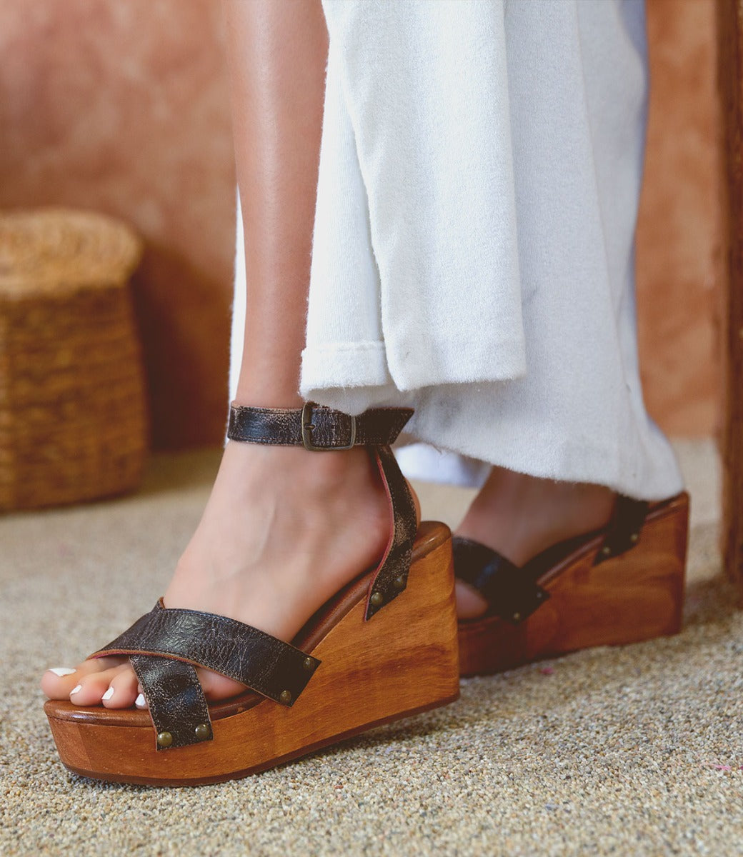 A woman's feet in a pair of Bed Stu Grettell wooden sandals.