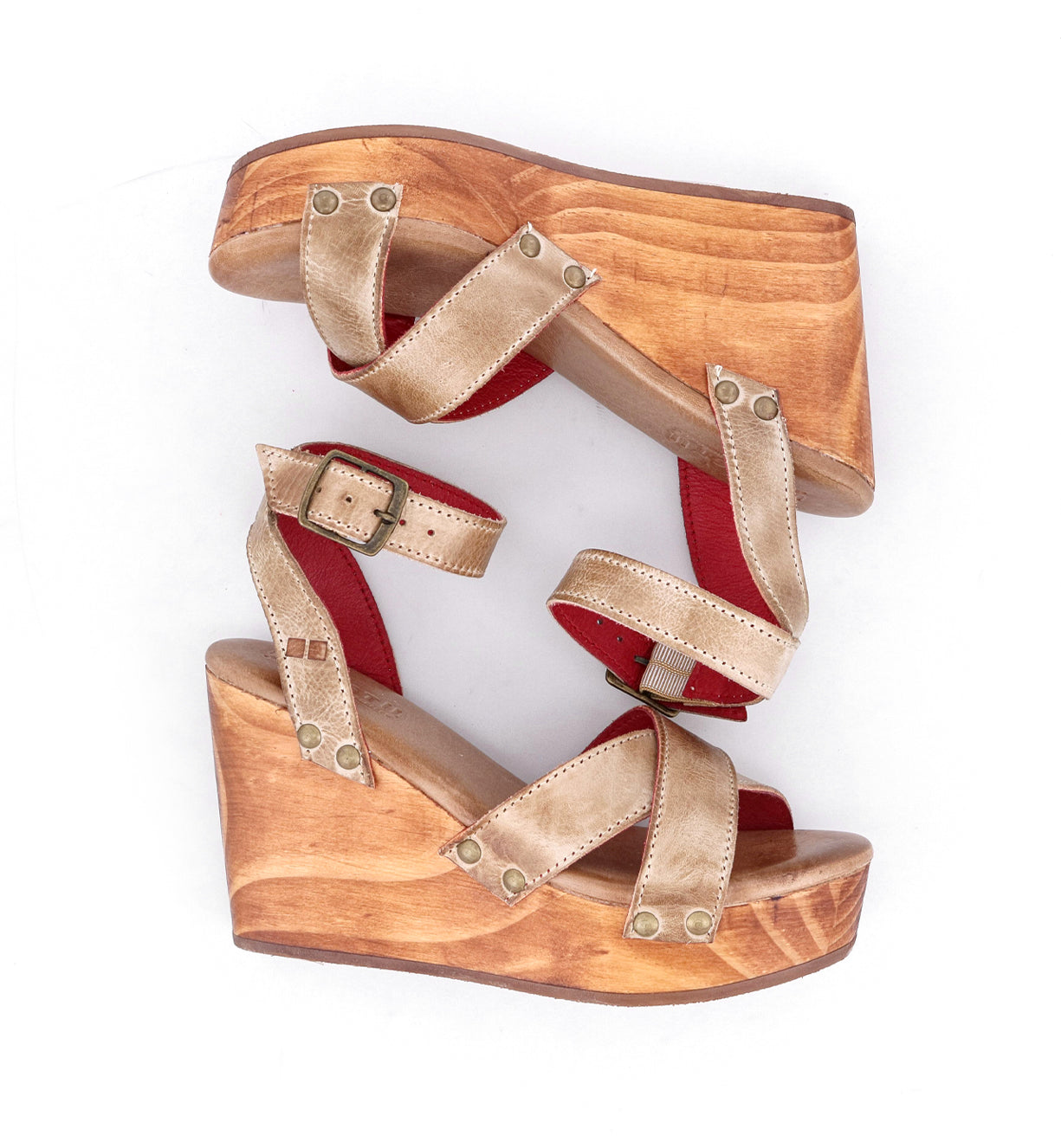 A pair of Grettell wooden wedge sandals with red straps made by Bed Stu.