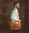 A man wearing a Bed Stu Hampton II leather shoulder bag.